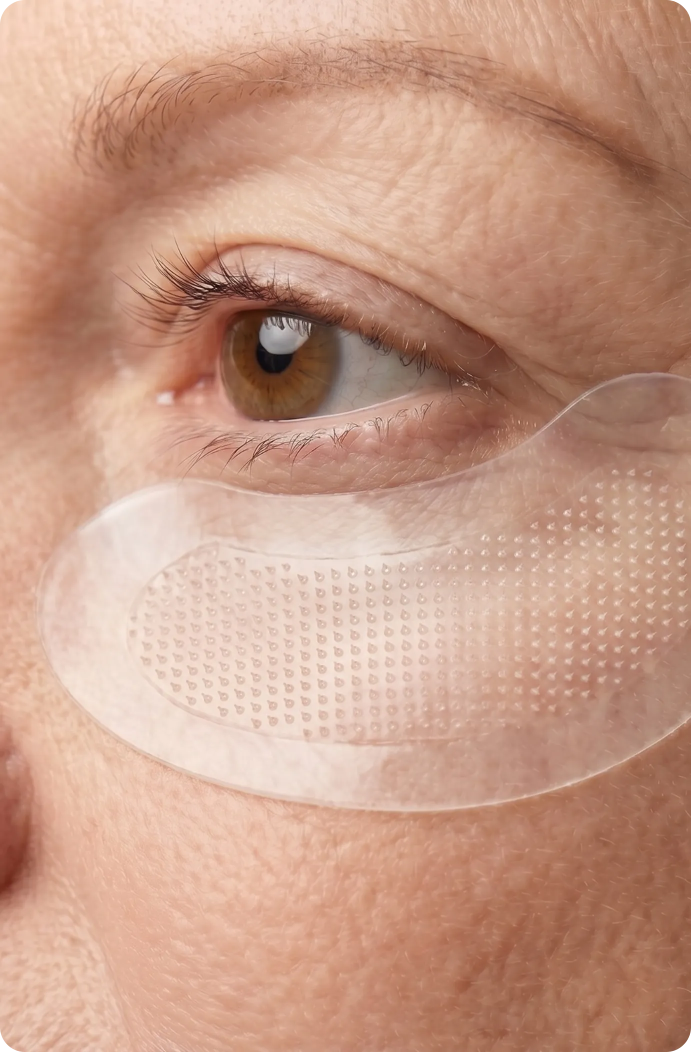 Close-up of a Renewa Skin micro-infusion patch beneath the eye