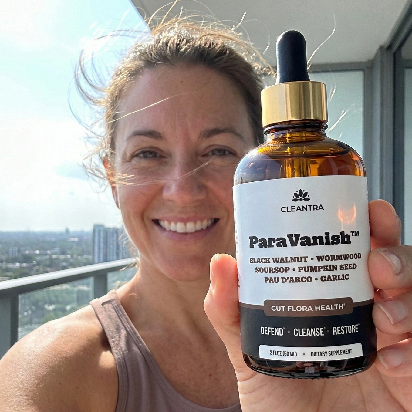 Woman holding ParaVanish bottle