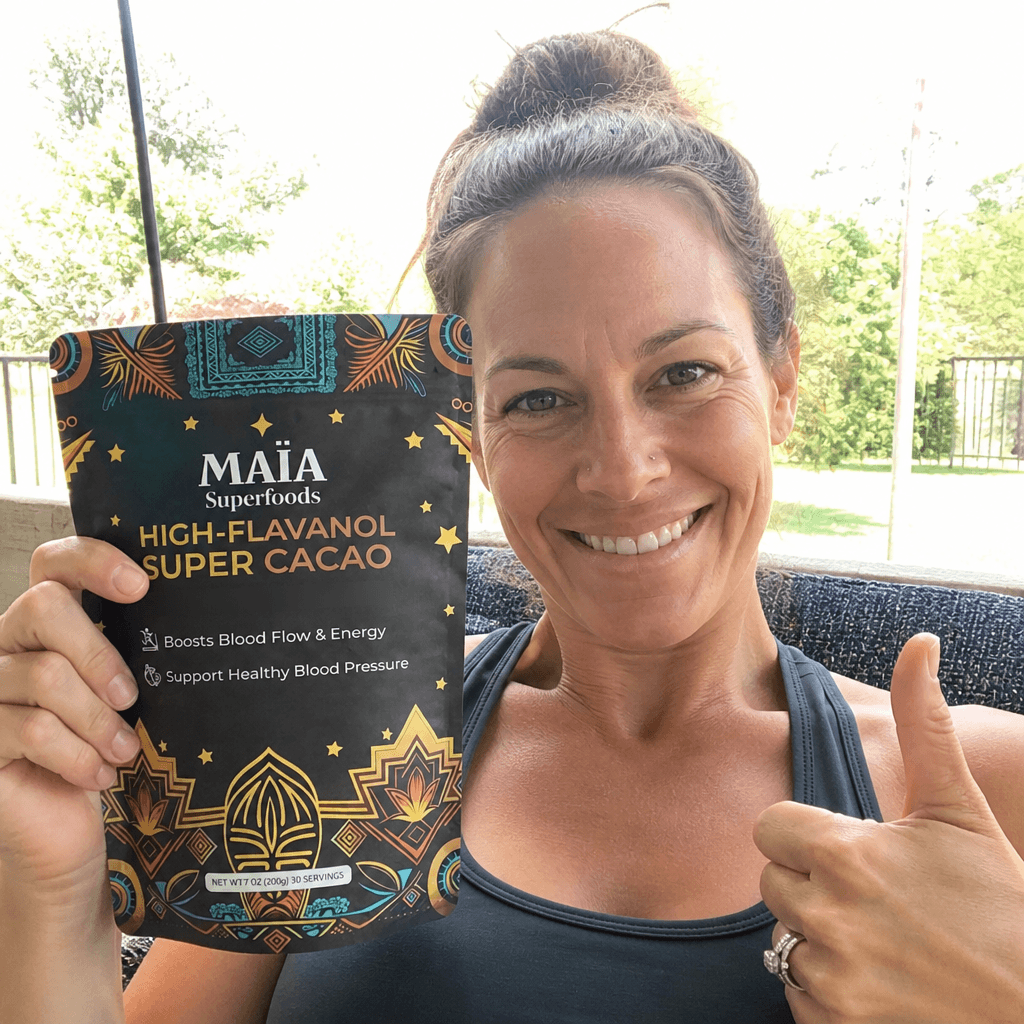 Person holding a Maia ceremonial cacao package outdoors.