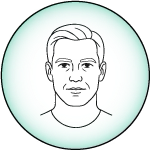 Person whisking a beverage in a kitchen near a knife block and packaged goods.