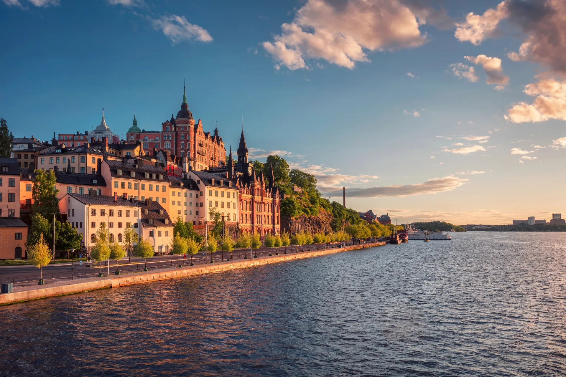A waterfront row of colourful houses at sunset in Sweden